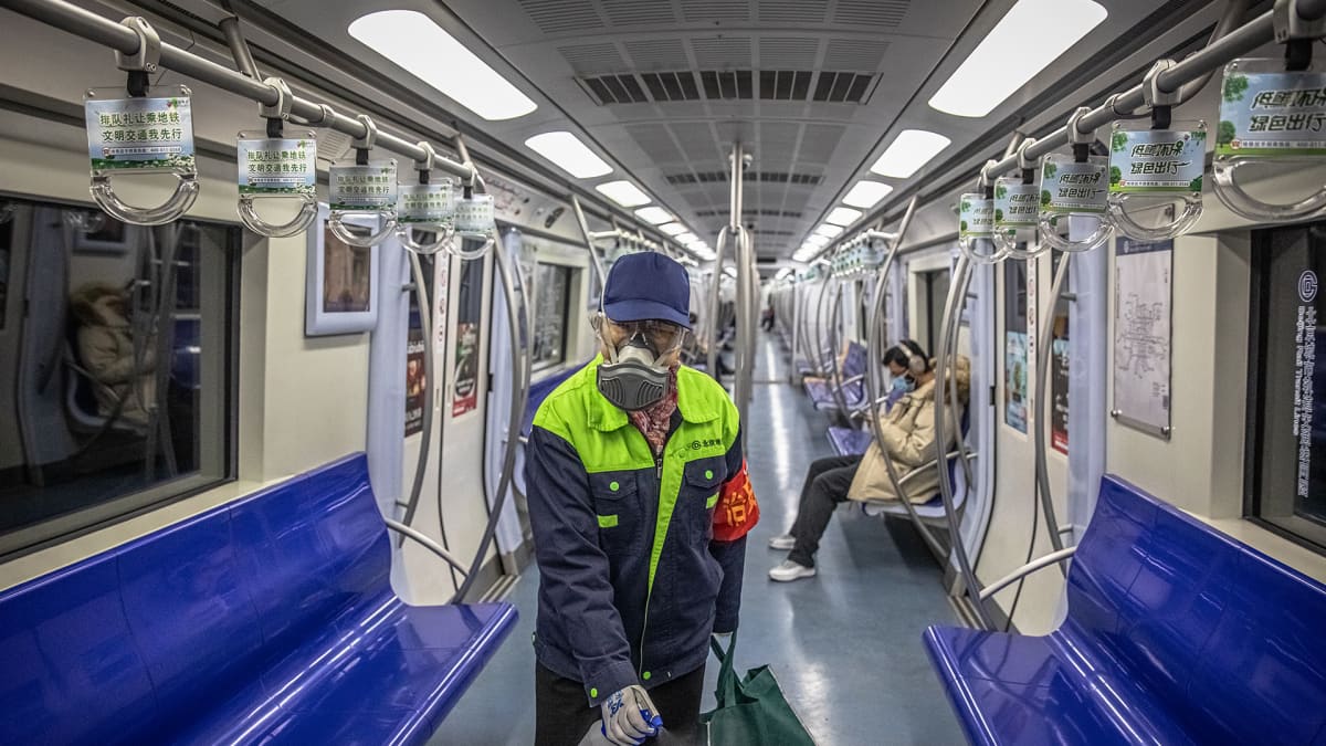 A subway worker wearing a protective face mask and eyewear disinfects a subway carriage in Beijing, China, 10 February 2020. Major China's cities began going back to work after the Lunar New Year holiday, which was extended in an attempt to contain the spread of the deadly coronavirus across the country.