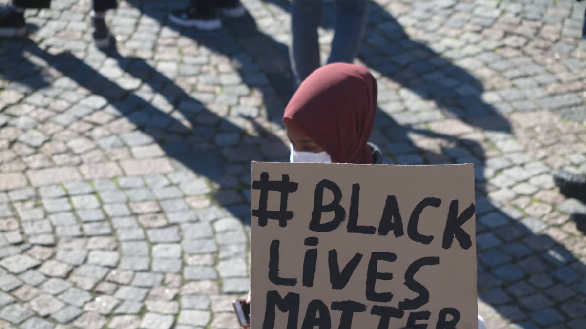 A participant holds a sign reading "black lives matter" at an anti-racism demonstration held in Helsinki on 3 June 2020.