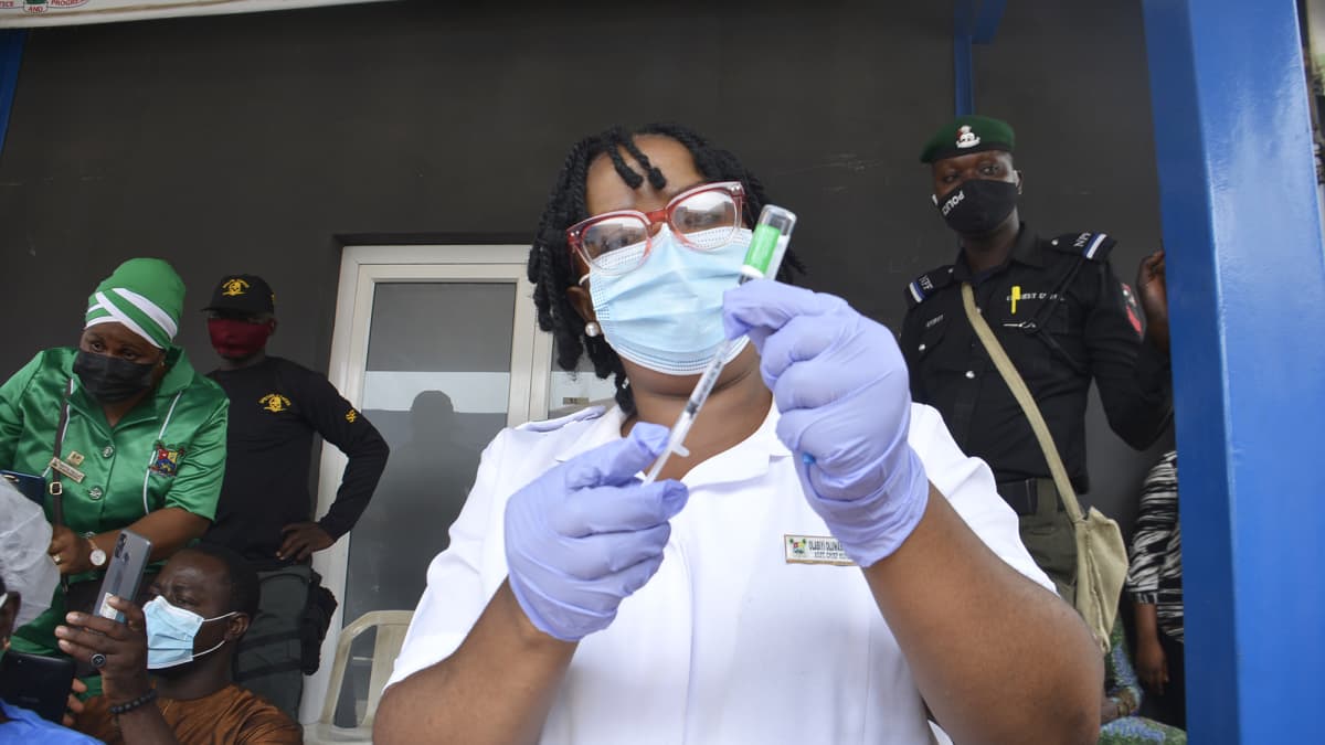 Nigerialainen terveydenhuollon työntekijä valmistelee AstraZeneca koronavirusrokotetta.