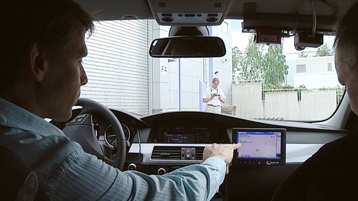 Kuljettaja esittelee VTT:n koejärjestelmän näyttöruutua auton kojelaudassa.