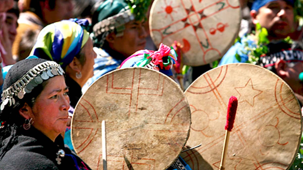 Mapuche-intiaanit marssivat soittaen perinteisiä Kultrun-soittimia.