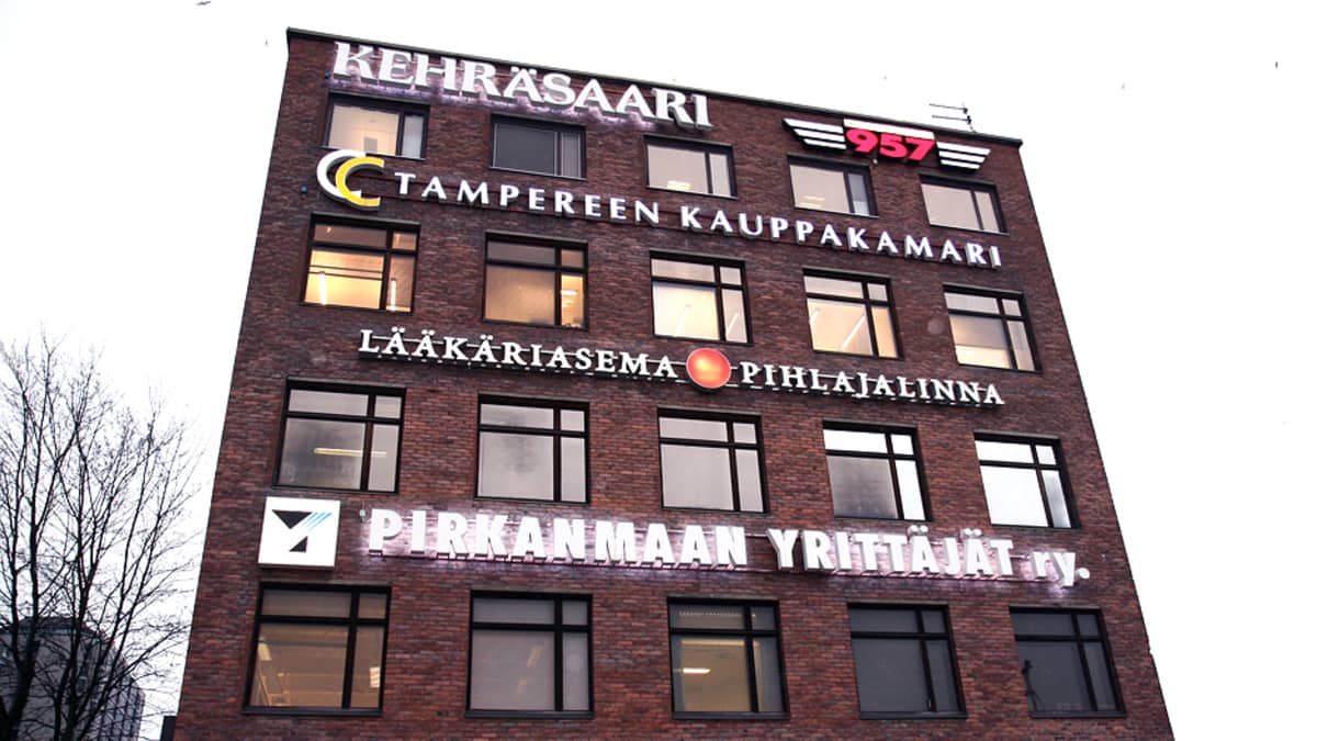 Rakennus Kehräsaaressa Tampereella. Talon seinässä useita valomainoksia. 