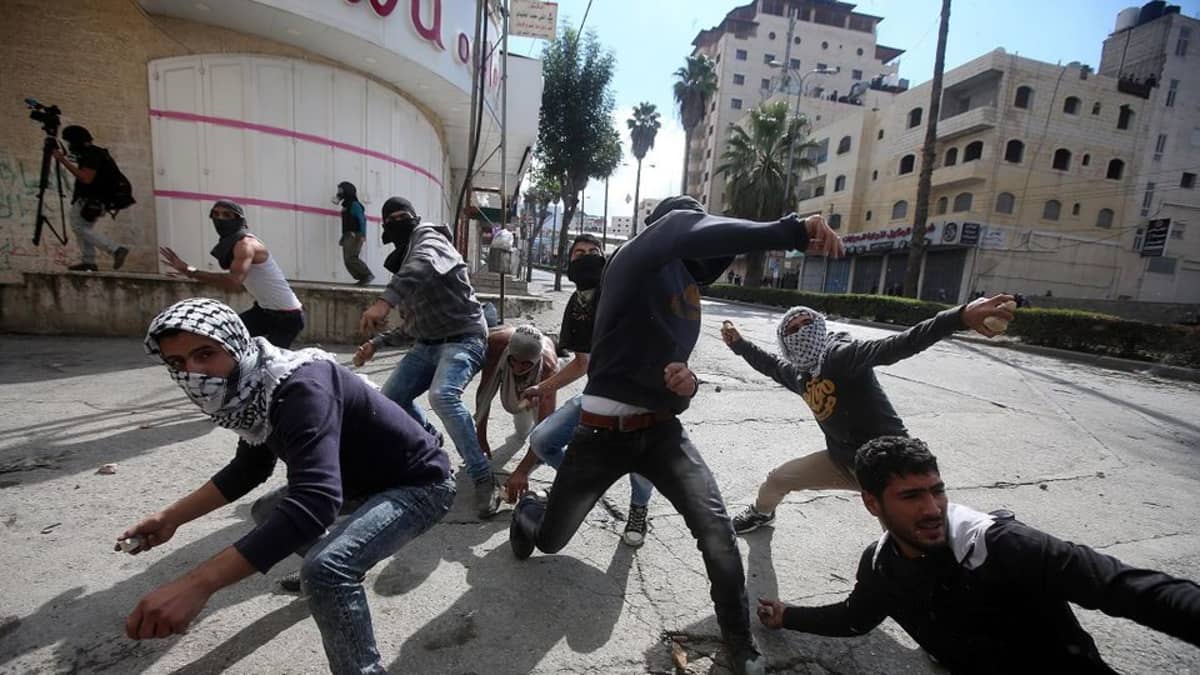 Palestiinalaiset nuoret heittelivät Israelin sotilaita kivillä Hebronissa Länsirannalla 30. lokakuuta 2015.