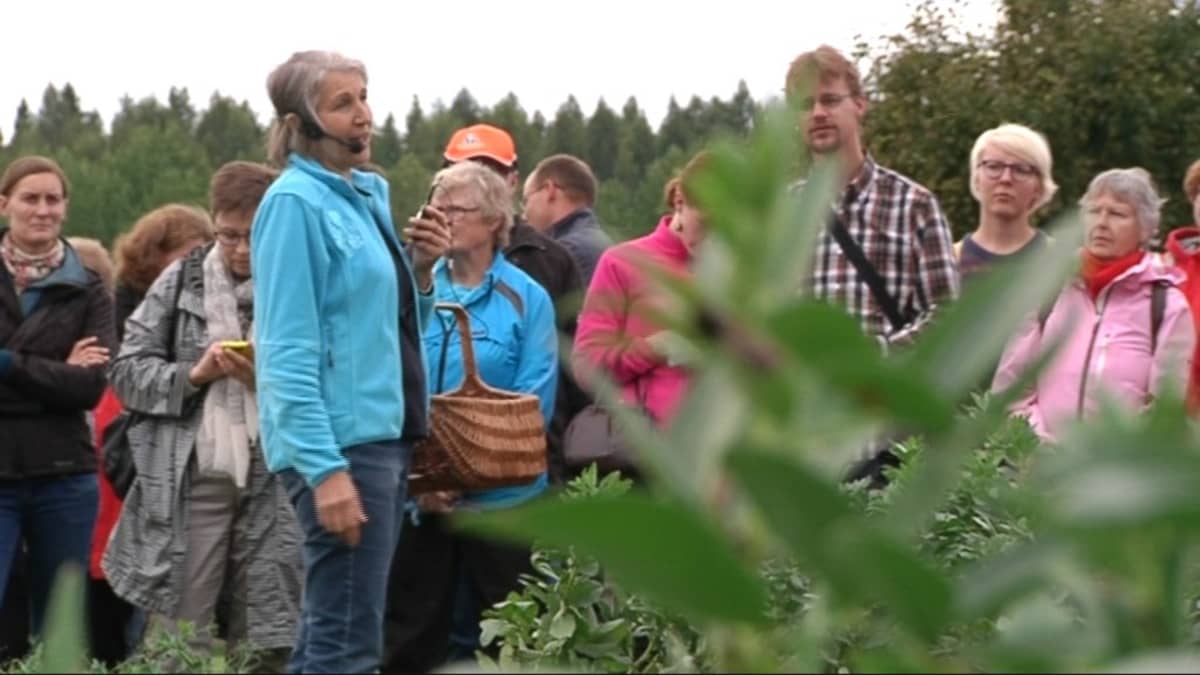 Nainen puhuu väkijoukolle