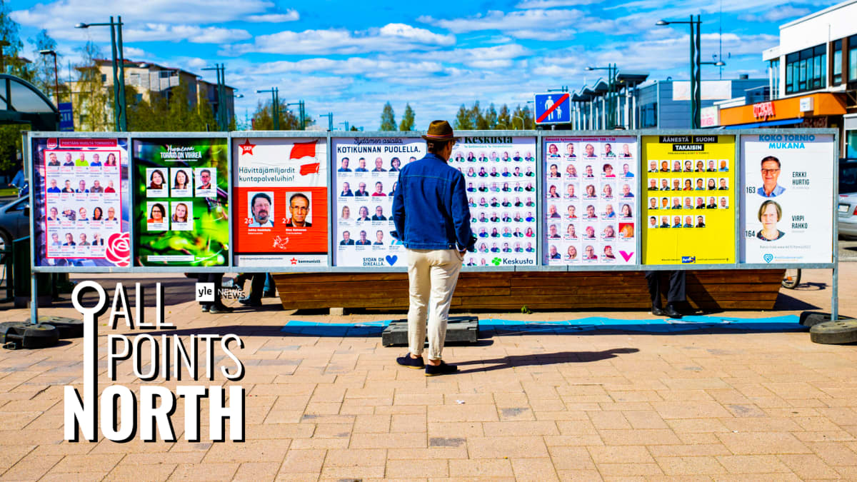 Photo of man looking at municipal election posters in Tornio, featuring All Points North podcast logo.
