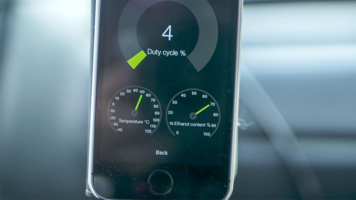 Lähikuva iPhonen näytöstä, jolla pyörii eFlexFuel-etanolimuutossarjan applikaatio. Näyttää ruiskutussuuttimien käyttöasteen, polttoaineen lämpötilan ja polttoaineen etanolipitoisuuden.