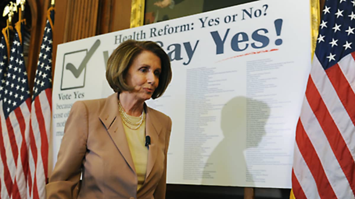 Demokraattijohtaja Nancy Pelosi terveysuudistuksta puoltavan julisteen edessä