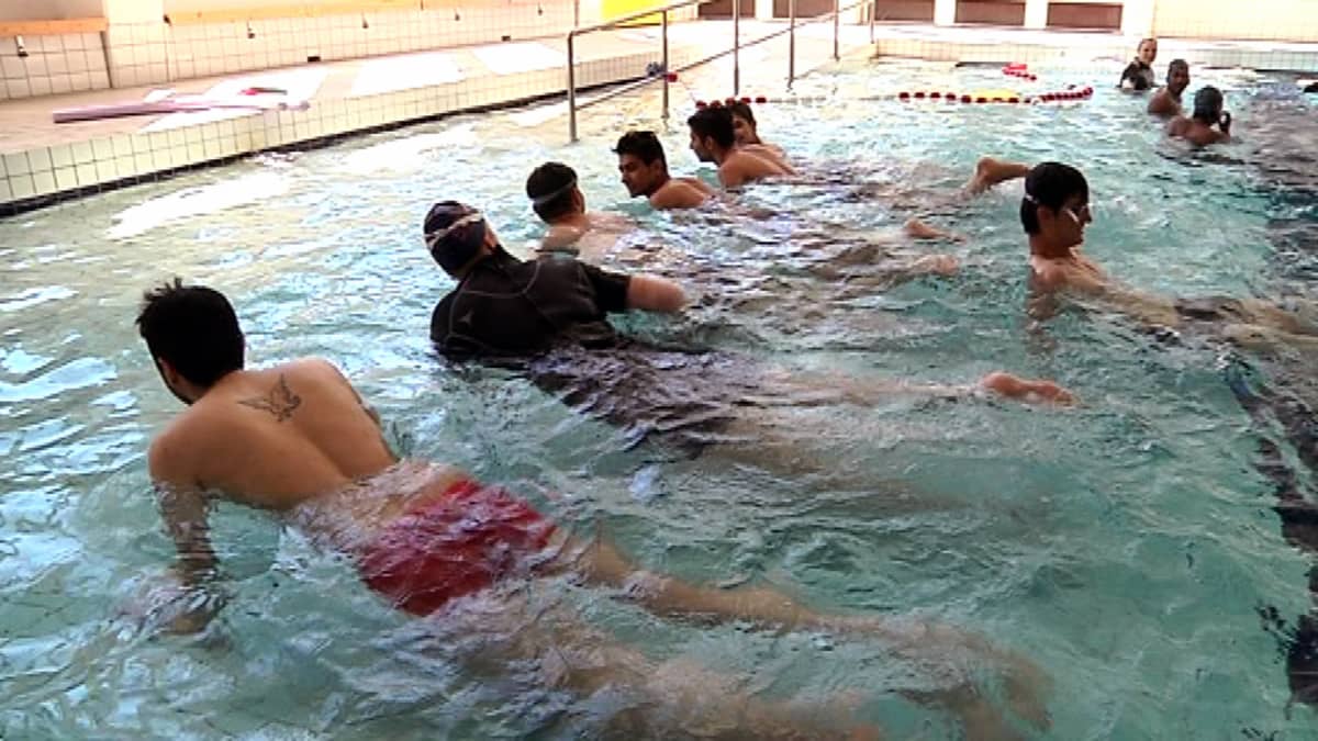 Maahanmuuttajia ja turvapaikanhakijoita opettelemassa uimaan Jyväskylän uimahallissa.