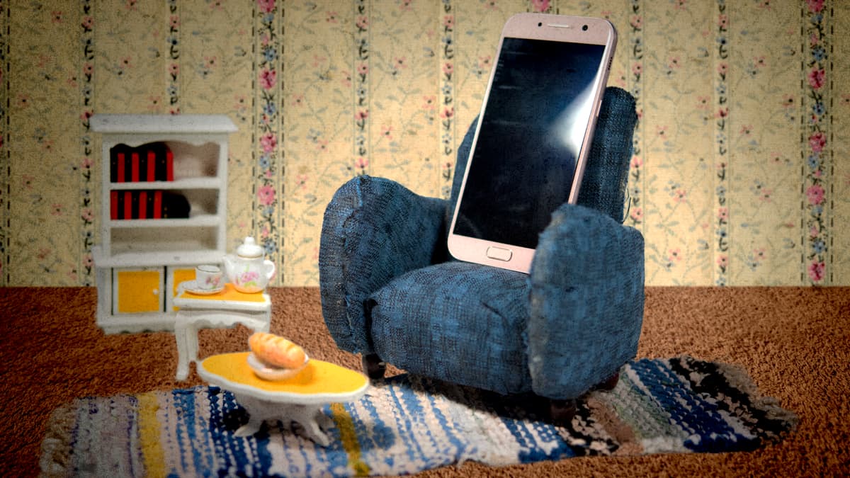 Kuvituskuva, jossa kännykkä istuu nojatuolissa.