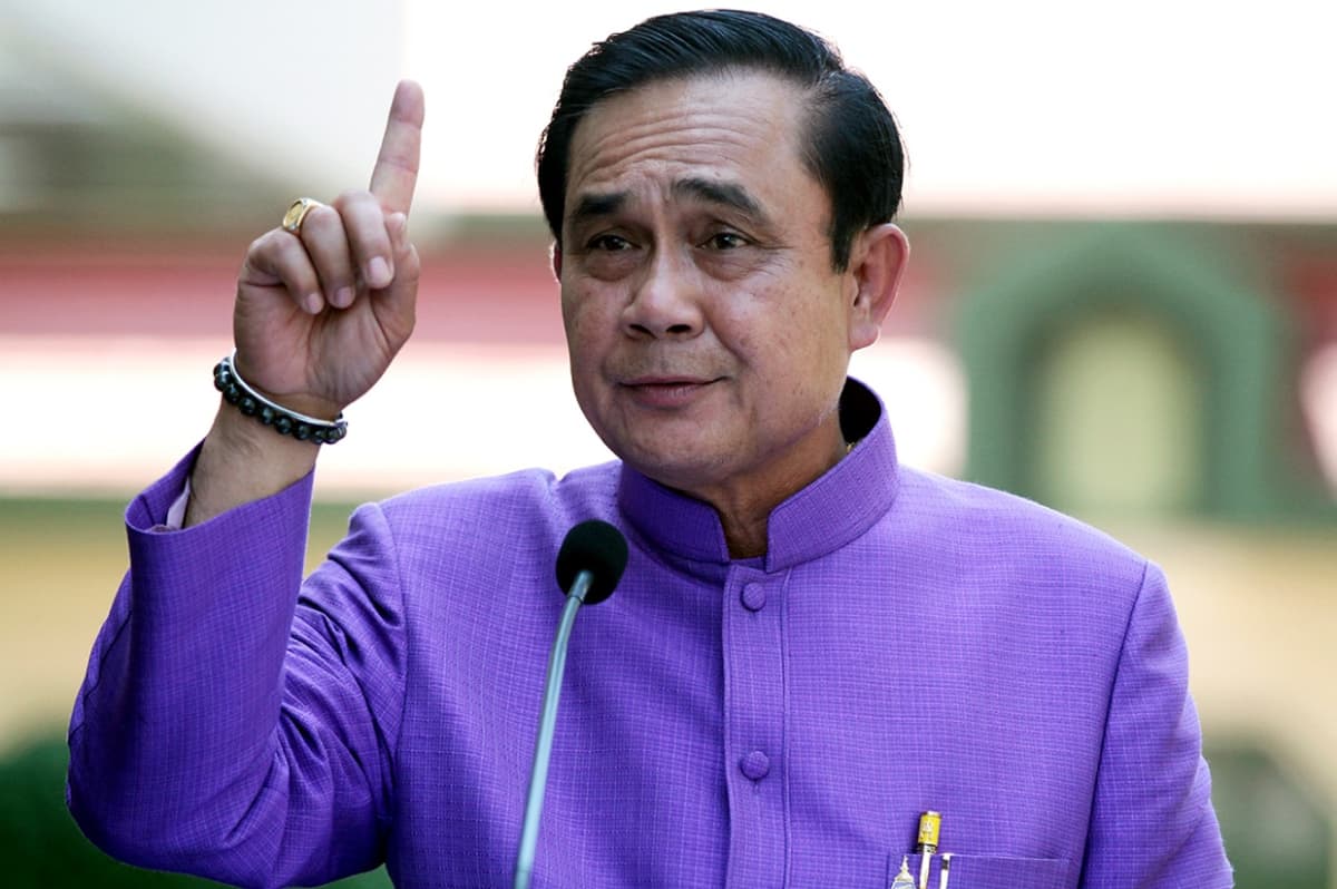 Thaimaan pääministeri sormi pystyssä ilmoittaessaan sotatilalain kumoamisesta