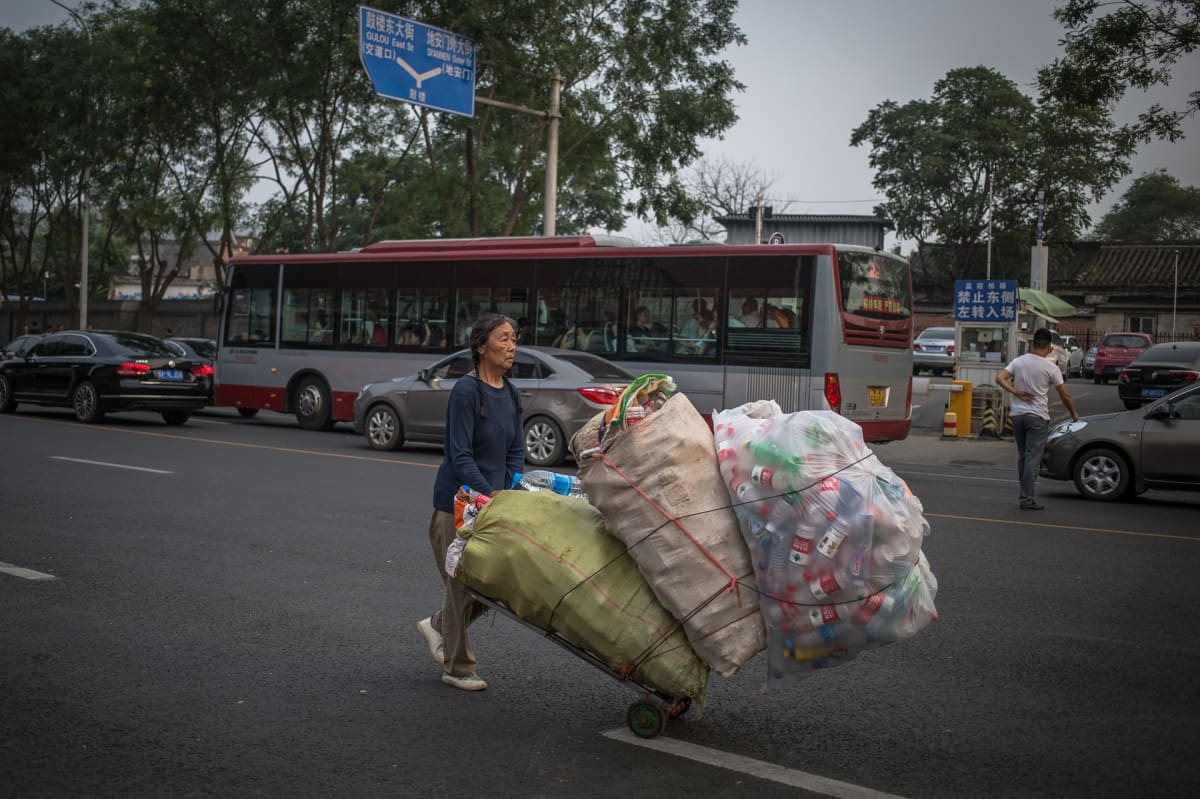 Nainen kerää muovipulloja Pekingissä.