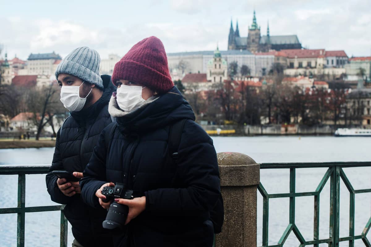 Kuvassa on hengityssuojainta käyttäviä turisteja Prahassa.