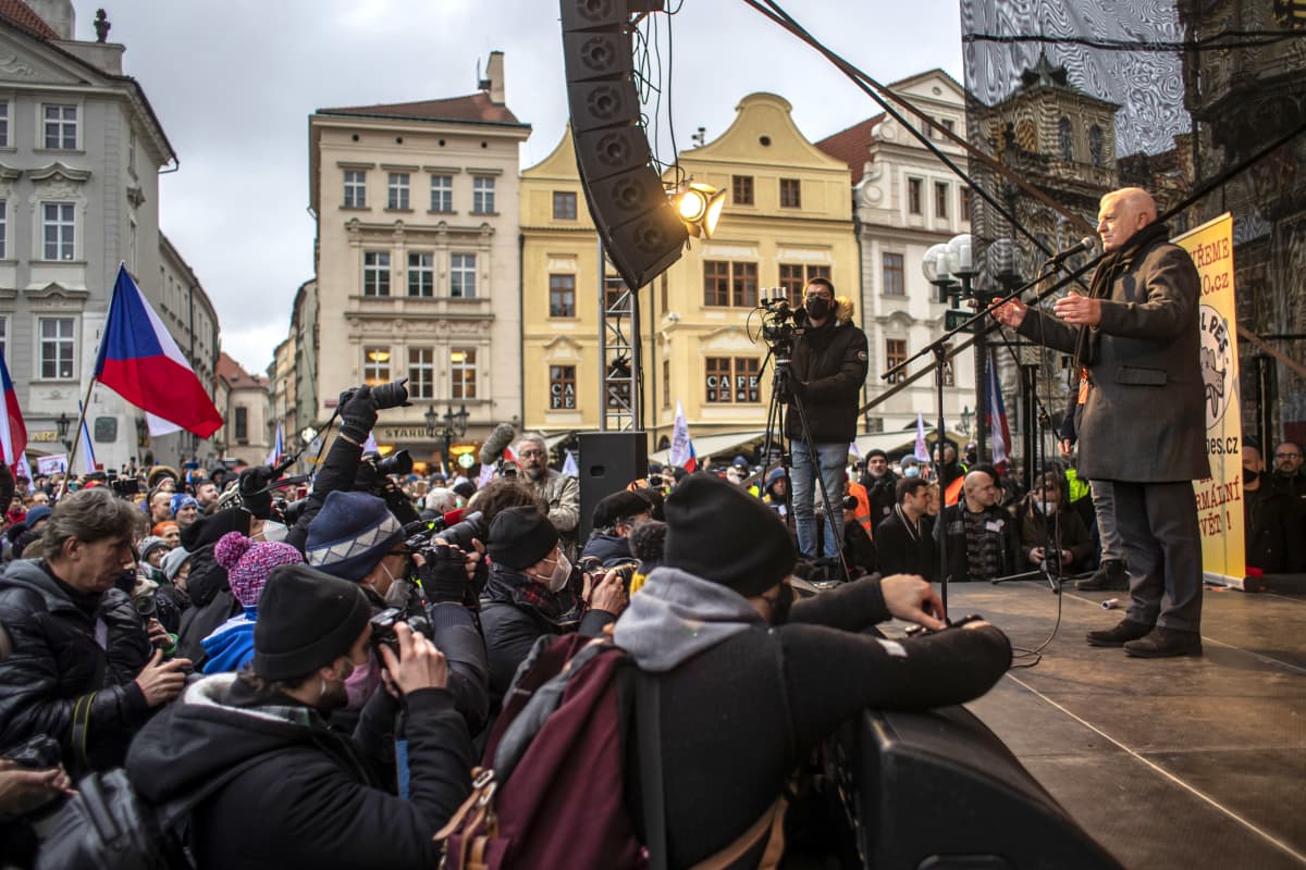 Vaclav Klaus lavalla ihmisjoukon edessä, eturivissä valokuvaajia