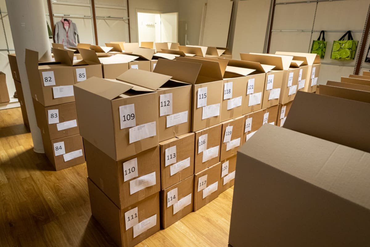 Vähävaraisten perheiden mukaan numeroituja pahvilaatikoita Hope ry:n varastossa. Laatikoita on monessa kerroksessa ja useassa rivissä.