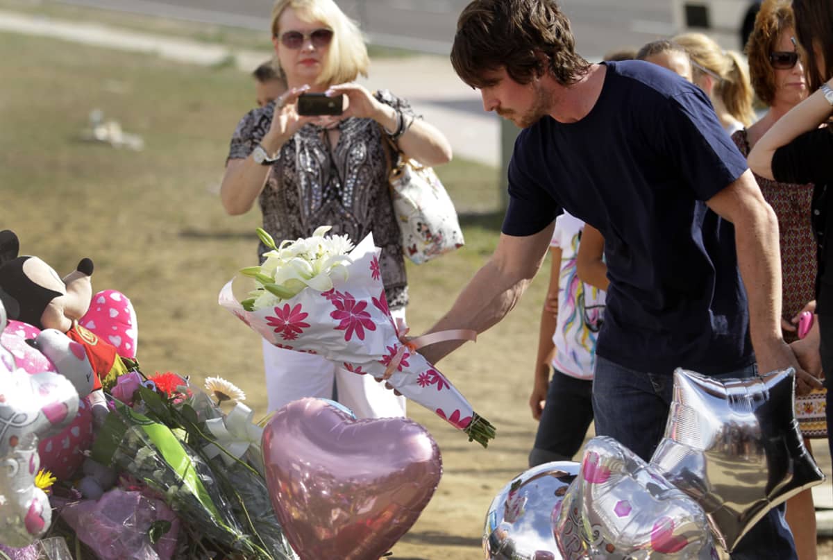 Näyttelijä Christian Bale laskee kukat ammuskelussa kuolleiden muistolle Aurorassa Coloradossa.