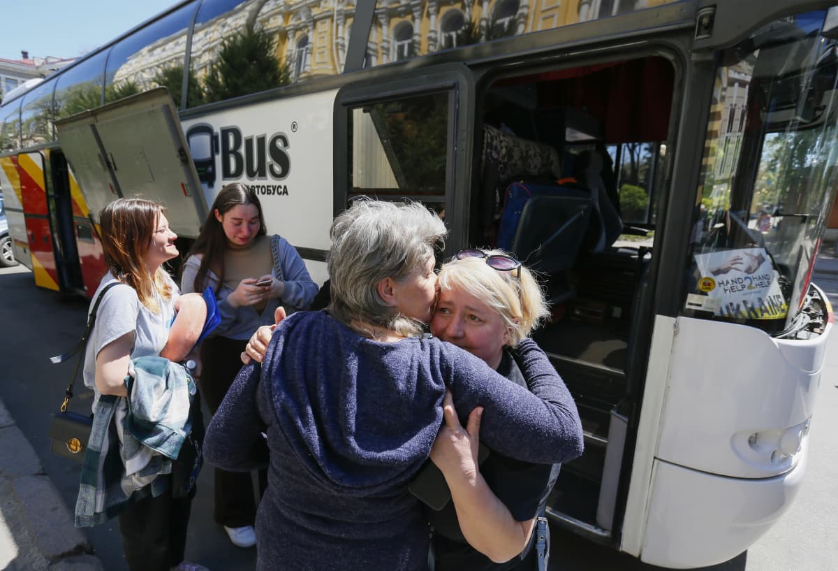 Ukrainalaiset hyvästelemässä ystäviää ja sukulaisiaan jotka ovat lähdössä Italiaan bussilla.