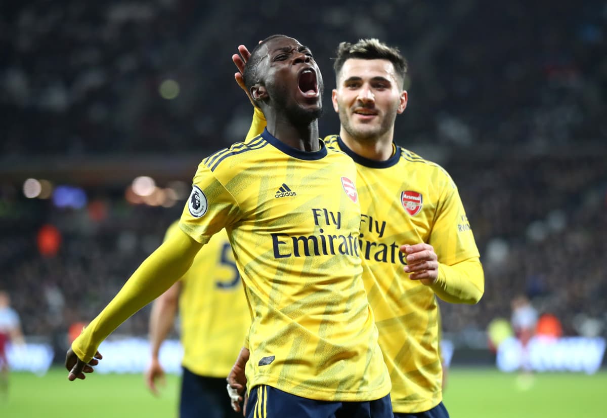 Nicolas Pepe of Arsenal celebrates after scoring his sides second goal with Saed Kolasinac during the Premier League match between West Ham United and Arsenal FC at London Stadium on December 09, 2019 in London, United Kingdom. (Photo by Julian Finney/Getty Images