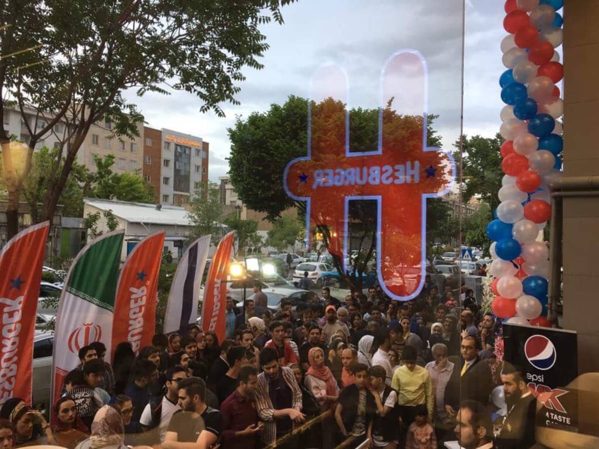 The view of a crowd lined up outside Hesburger's new location in Tehran, Iran, which opened for the first time on Friday.