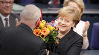 Angela Merkel vastaaottaa kukat parlamentissa tultuaan valituksi kolmannelle kaudelleen liittokanslerina.