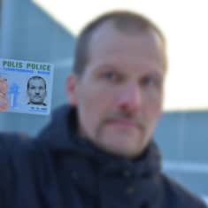Poliisi esittää virkamerkkinsä. 