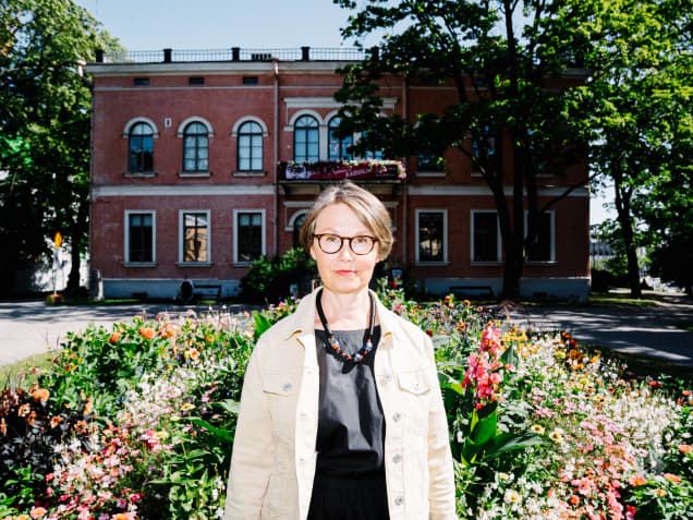 Helsingin kaupunginmuseon tutkimuspäällikkö Minna Sarantola-Weiss seisoo Hakasalmen huvilan pihamaalla.