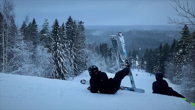 Skiers are lying on the slope