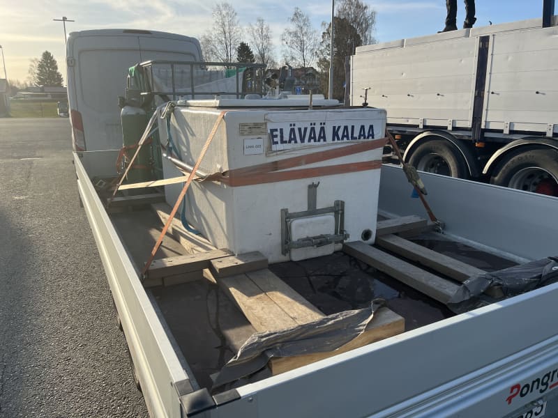 A transport box for fry on a car platform.