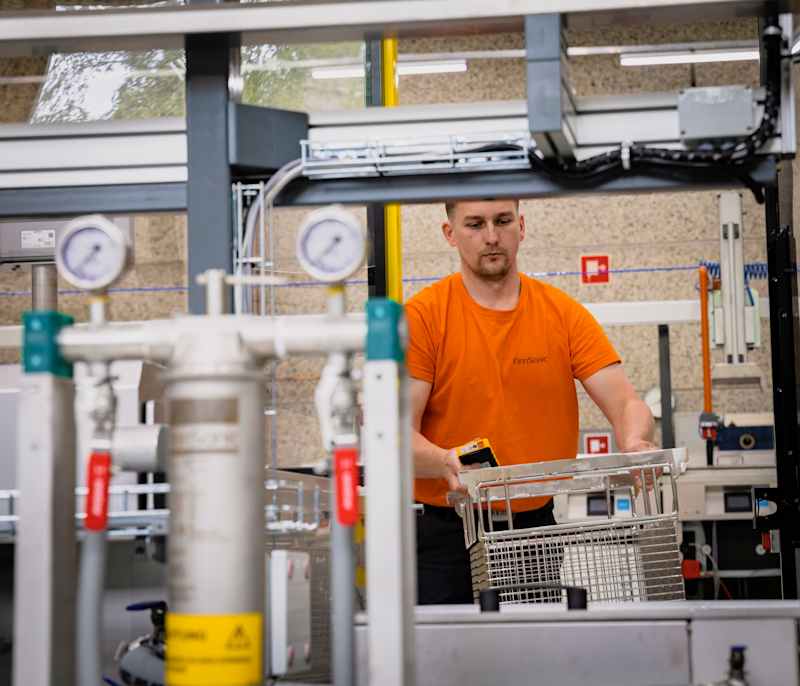 A Finnsonic employee tests the ultrasonic cleaner at the factory.