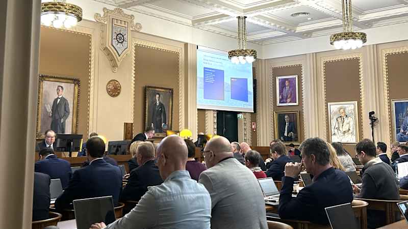 People sit on a chair and look ahead in the council hall of Lahti.