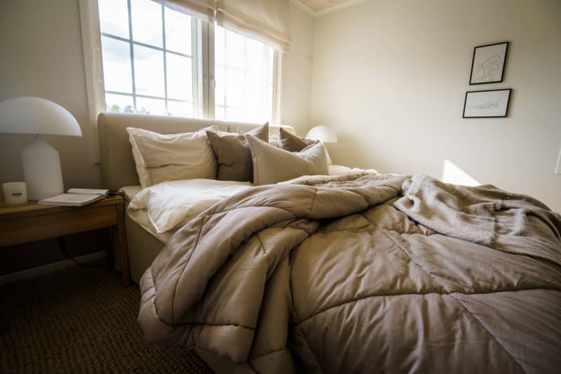 A bedroom with an unplaced double bed.