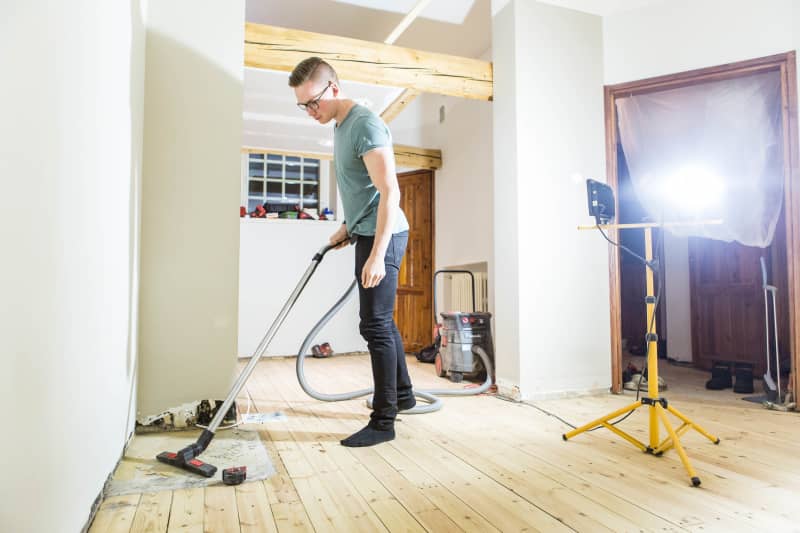 Daniel Schmidt Vacuums the future Airbnb apartment.