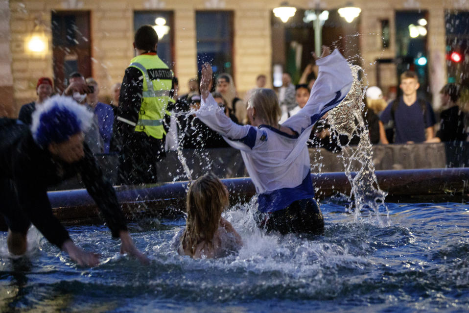 People were excited to swim in the pool of the Manta statue, even though Finland did not win the World Hockey Championships.
