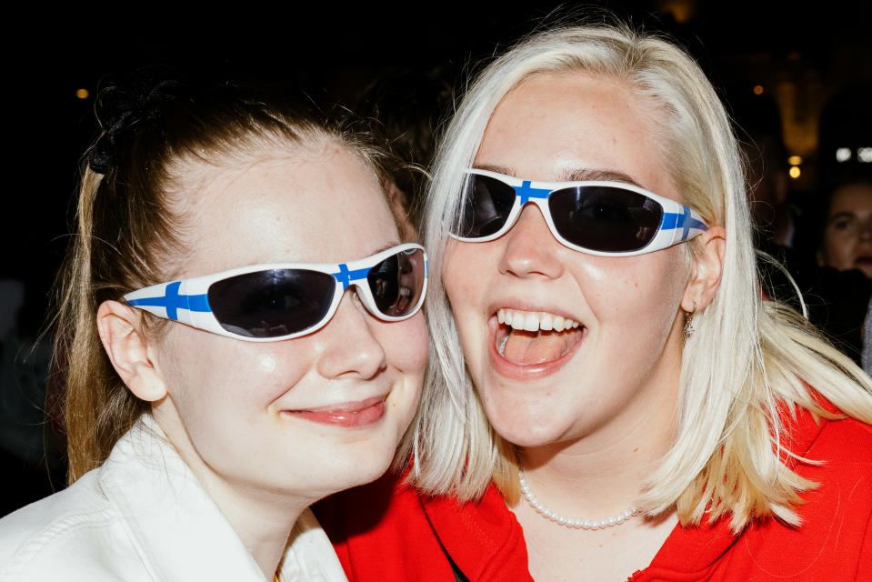 Women posing with Finnish glasses on their heads.