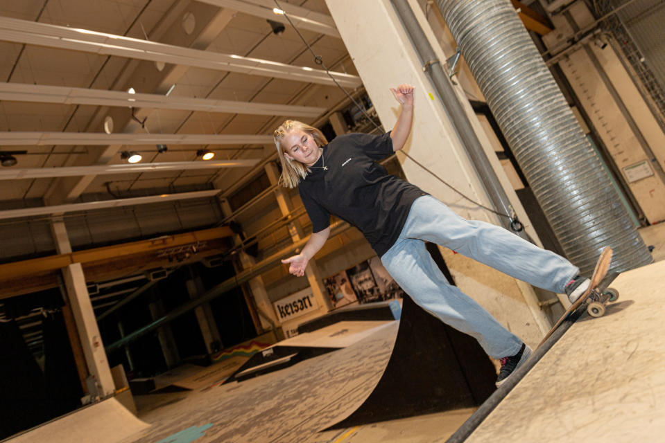 Oona Kaskinen does a trick on a ramp in a skate hall.