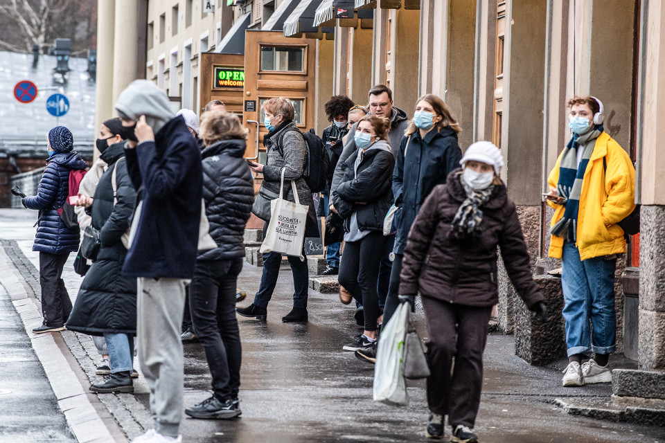 Ihmisiä odottamassa bussia Helsingissä.
