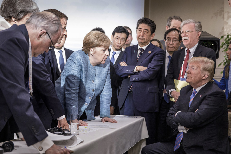 French President Emmanuel Macron, German Chancellor Angela Merkel and Japan's Prime Minister Shinzo Abe speaking to US President Donald J. Trump during the second day of the G7 meeting in Charlevoix, C