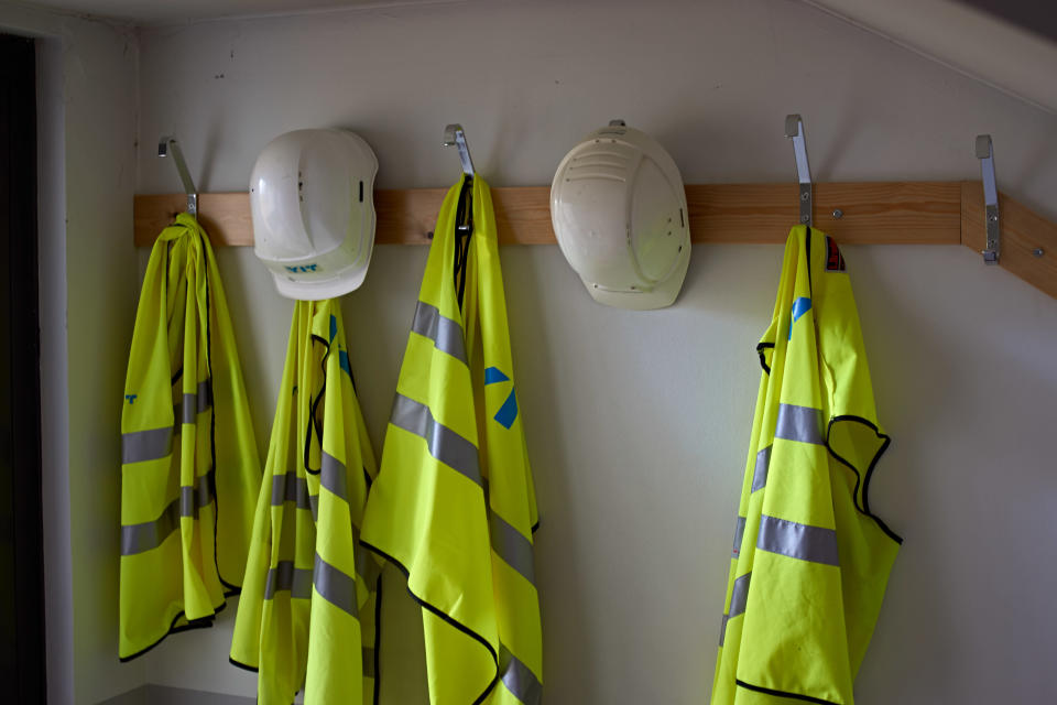 Construction site, safety guards and helmets in the hanger