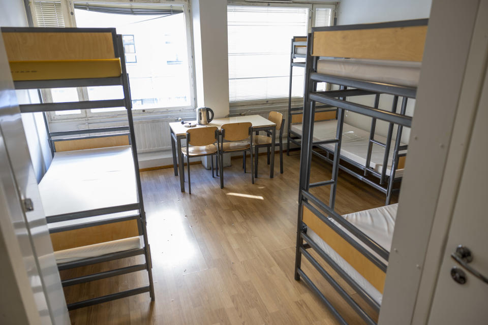 Room with bunk beds and a table with chairs.