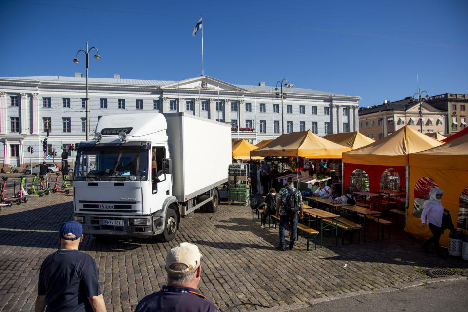 Kuorma-autoa puretaan lastista kauppatorilla.